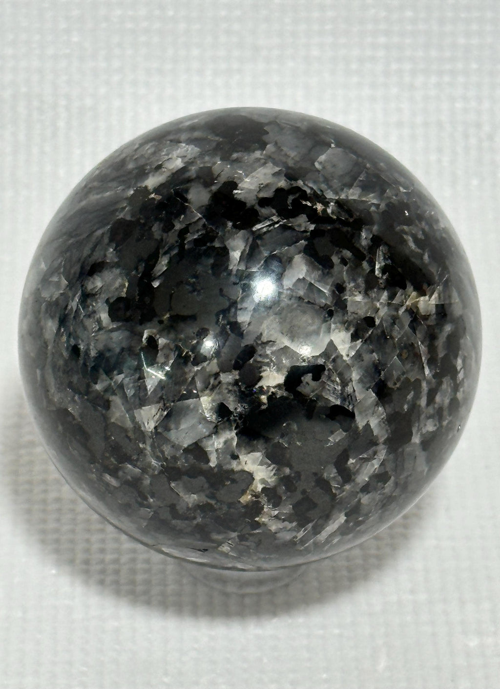 Small polished black crystal sphere mineral specimen for collection, display, decor