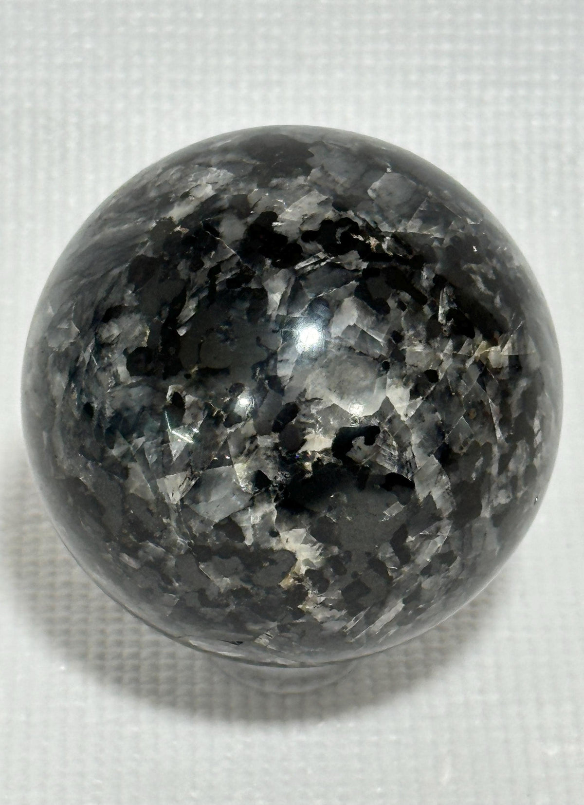 Small polished black crystal sphere mineral specimen for collection, display, decor
