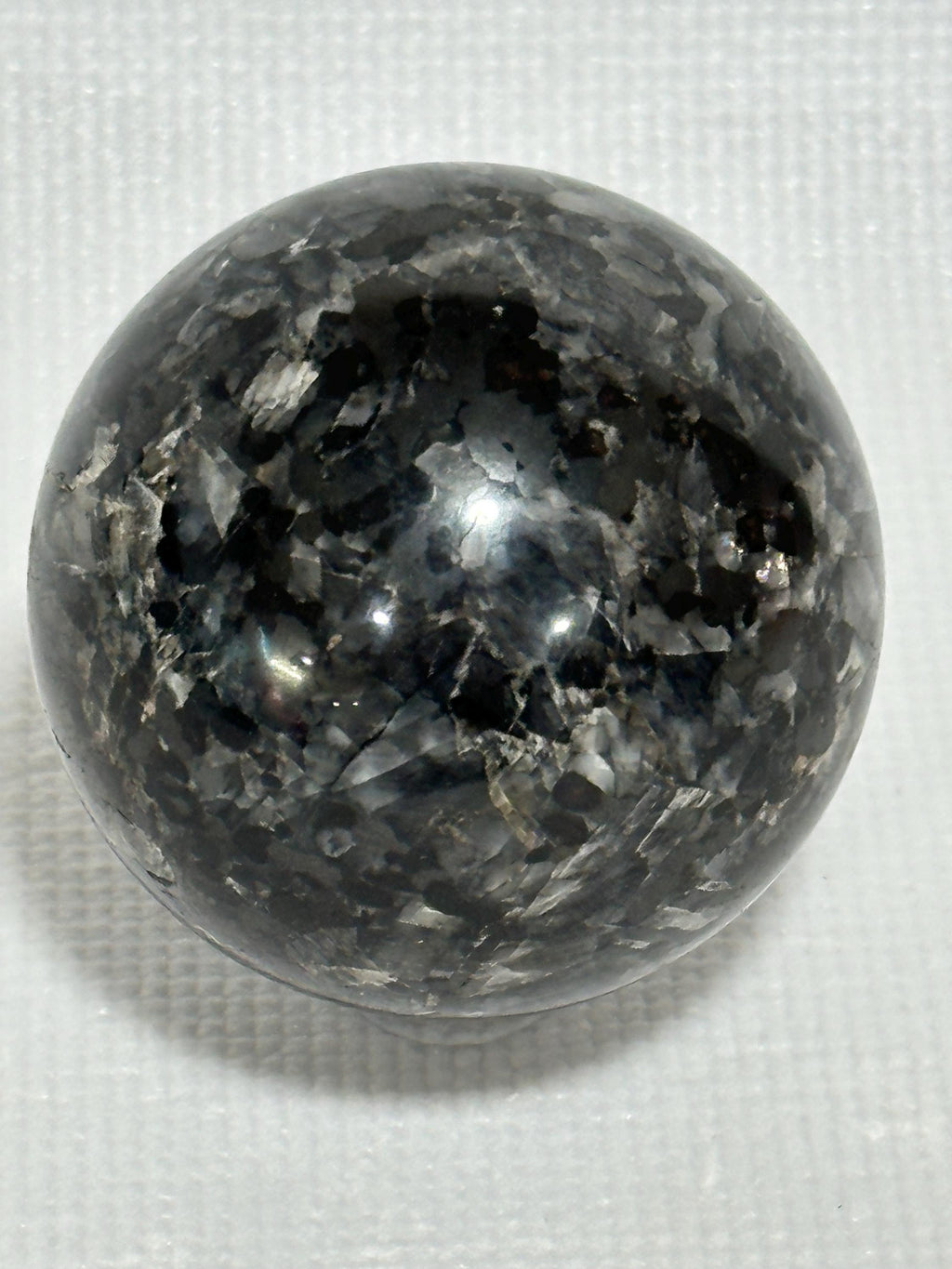 Small polished black crystal sphere mineral specimen for collection, display, decor