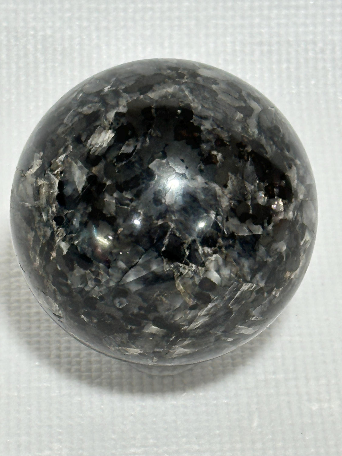 Small polished black crystal sphere mineral specimen for collection, display, decor