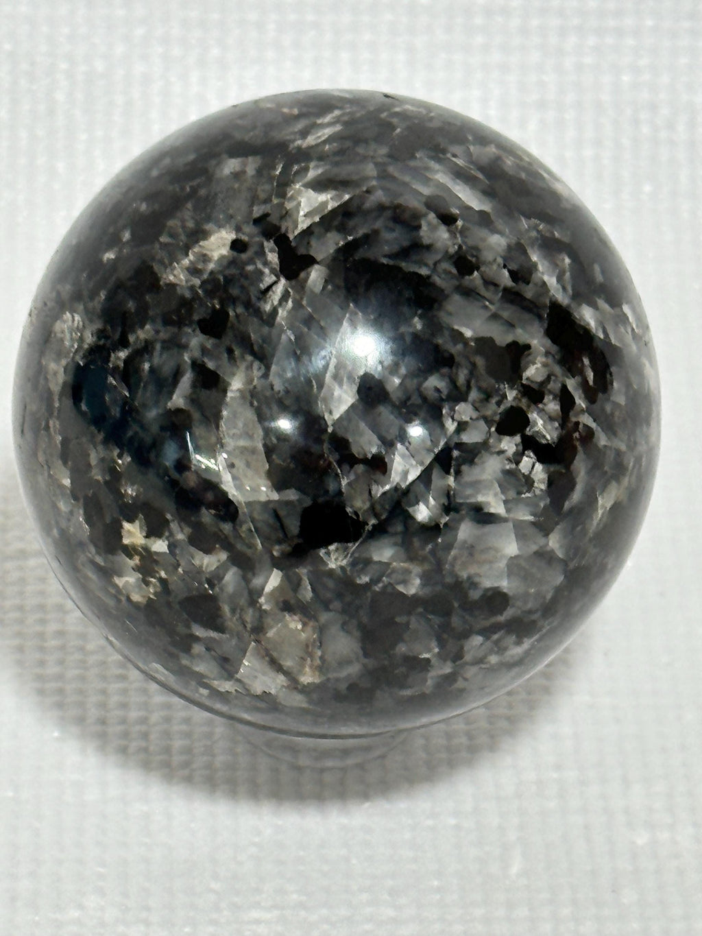 Small polished black crystal sphere mineral specimen for collection, display, decor
