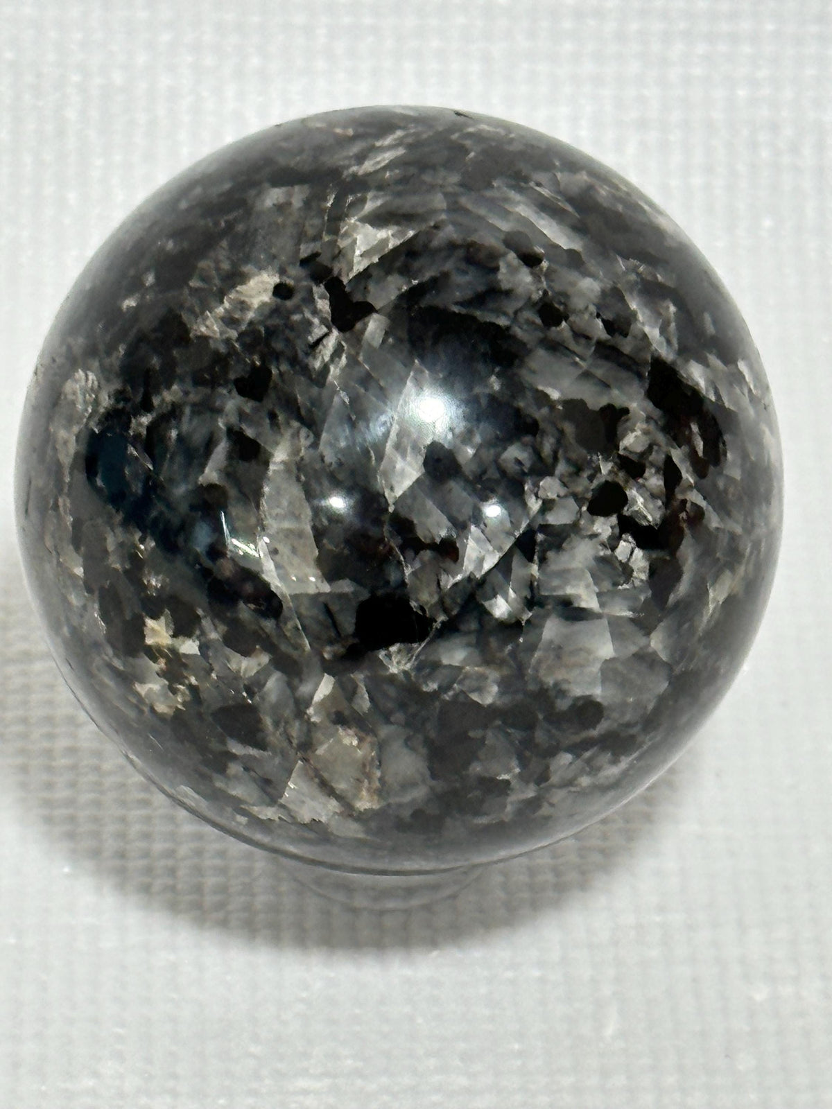 Small polished black crystal sphere mineral specimen for collection, display, decor