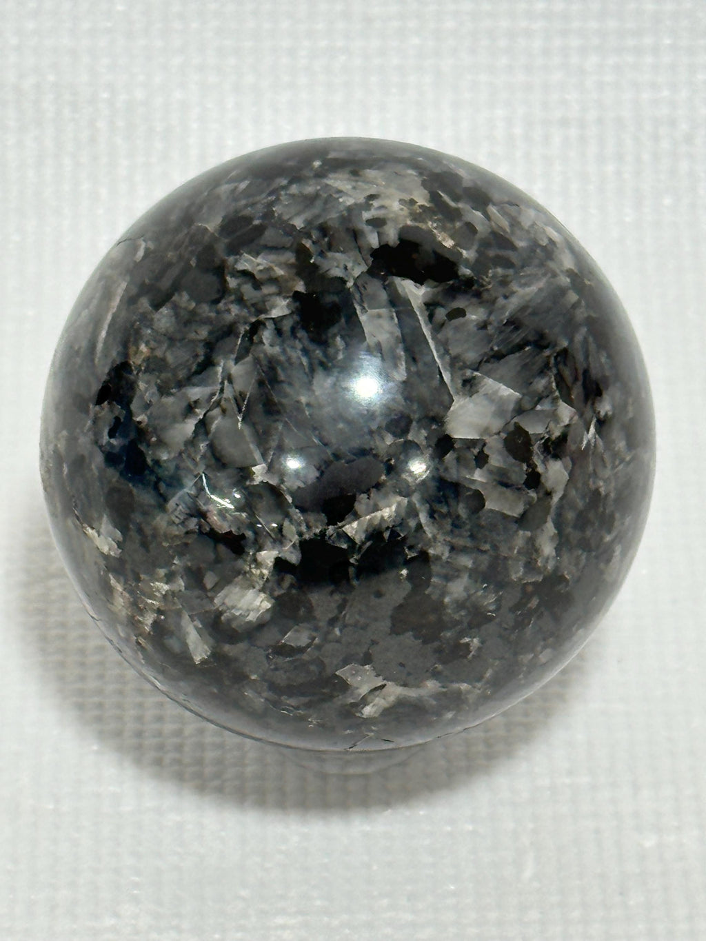 Small polished black crystal sphere mineral specimen for collection, display, decor