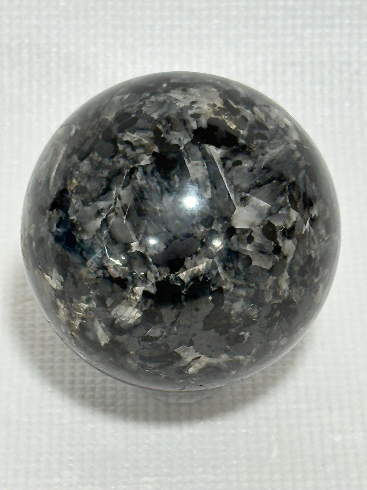 Small polished black crystal sphere mineral specimen for collection, display, decor